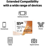 Silicon Power 256GB flash memory card being inserted into a handheld mobile gaming console slot.