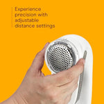 White and gray portable fabric shaver with charging cord