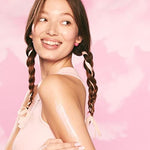 Glow Recipe USA imported body moisturizer tube laying down on a pastel clean surface.