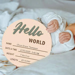 Cephira baby monthly milestone markers disc showing the detailed smooth edges and natural wood grain texture