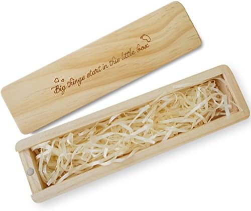 Open view of the wooden pregnancy announcement box with decorative raffia ribbon inside