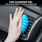 Reusable blue cleaning gel being pressed into car AC vents to remove dust particles