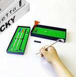 Close up of metal golf club ballpoint pens on desk