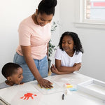 Close up view of the clear plastic sheets showing separate colorful handprints for a generational baby keepsake.