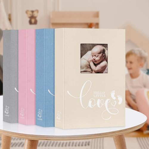 Angled view of the pink Lanpn baby milestone memory album as a nursery gift setup.