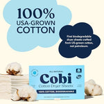 Biodegradable non toxic cotton laundry sheet being pulled from the box close up view