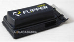 Flipper cleaning tool positioned on a small glass aquarium wall