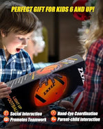 Youth player catching the ZXYZZ glowing football during a nighttime game