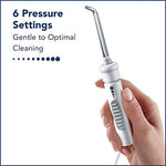 Close up of Waterpik Classic Professional 360 degree rotating flosser tip and handle switch.