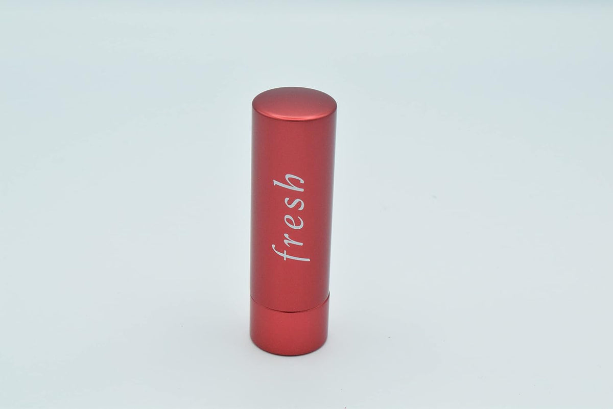 Fresh Sugar Lip Treatment open metallic red tube showing coral lip balm stick