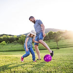 Vibrant purple and pink kids soccer ball resting on a green backyard lawn during outdoor play