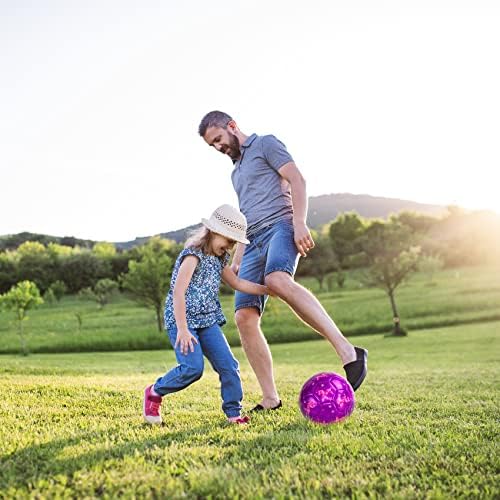 Vibrant purple and pink kids soccer ball resting on a green backyard lawn during outdoor play