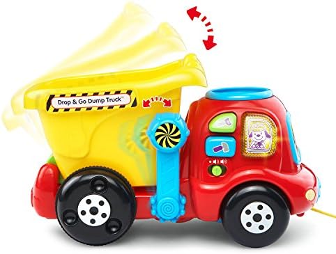 Toddler pushing the VTech interactive construction vehicle with colorful rocks inside