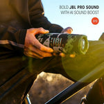 JBL Flip 7 speaker being used outdoors in a rugged environment