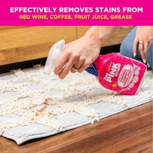 The Pink Stuff Miracle Foam being used on a grey fabric sofa upholstery