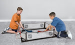 Franklin Sports Kids Knee Hockey Rink Game Set goals with sticks and pucks.