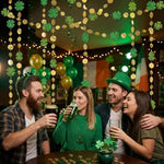 Close up view of Cheerland glittery green clovers and metallic gold circles sewn on silver string