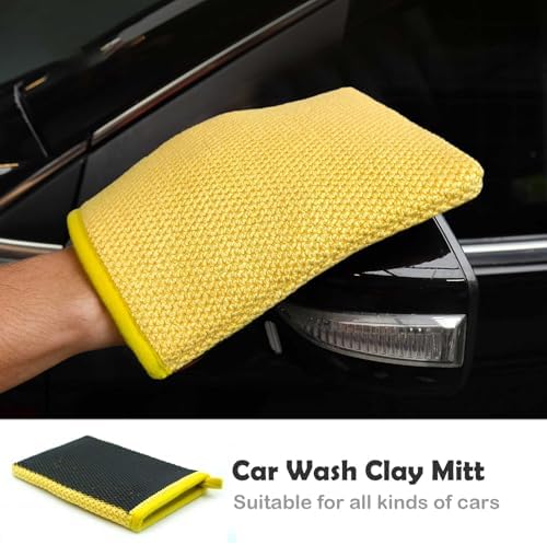 Rinsing a reusable car detailing clay mitt with water during an automotive wash sequence.