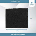 Organic activated carbon filter being trimmed with scissors to fit a hooded pet litter box compartment
