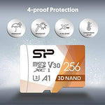 Silicon Power high speed 256GB memory card placed next to a compatible action camera and drone.