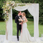 Versatile white sheer curtain used as an elegant event table runner background