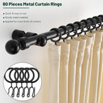 Side view of a matte black metal ring sliding smoothly on a one inch thick wooden curtain rod.