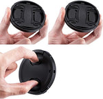 Two black center-pinch camera lens covers with elastic cap keeper strings detached.