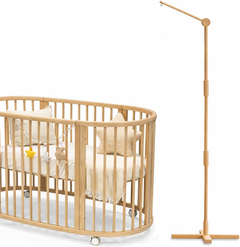 Lanttoe wooden floor standing crib mobile arm front view next to a modern oval baby cot