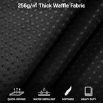 Close up shot of the luxurious honeycomb waffle weave pattern on the black fabric.
