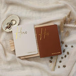Couple holding Zicoto wedding vow books during a ceremony