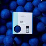 Packaging of the Capri Blue Volcano Dryer Ball Kit showing all components.