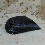 Construction worker using Jumbulk sandbags for site debris management