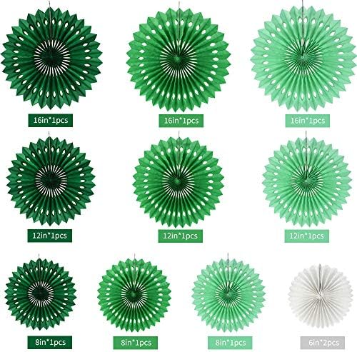 Assorted dark green light green and white paper fan decorations displayed elegantly on a celebration wall backdrop.