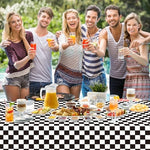 Wipeable and disposable black check table cloth protecting a long dining table from spills.