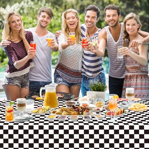 Wipeable and disposable black check table cloth protecting a long dining table from spills.