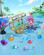 Close up of blue moldable sand with sea shell molds and gems