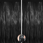 Two pack black metallic fringe curtains installed on a doorway as elegant entrance decorations.