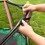 Folded and compact generic outdoor water toy sprinkler kit displayed alongside its secure nylon attachment zip ties.