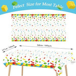 Three pieces of disposable lego theme table covers laid out for a kids birthday party setup
