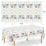 Close up of rainbow dots and Happy Birthday print on party tablecloth