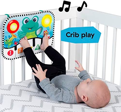 Baby Einstein Ocean Explorers Neptunes Kick Pad attached securely to the inside rails of a white wooden infant crib.