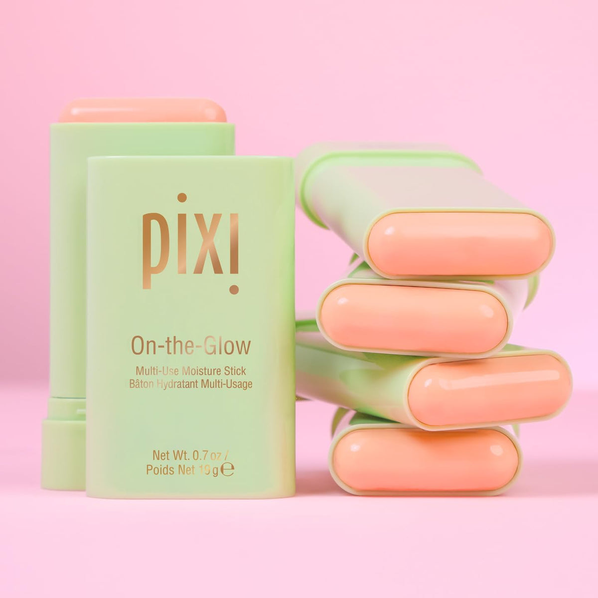 Model applying Pixi On The Glow stick to cheeks