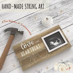 Elegant gender neutral nursery decoration item featuring a rustic wooden baby keepsake frame