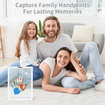 Baby handprint with parents keepsake frame being assembled on a table for home decoration.