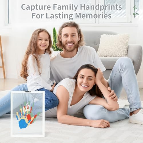 Baby handprint with parents keepsake frame being assembled on a table for home decoration.