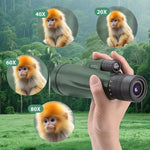 KTBDING outdoor telescope with smartphone adapter bracket attached to the eyepiece for mobile photography