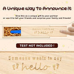 Husband surprise pregnancy reveal gift box filled with decorative raffia ribbon fibers.