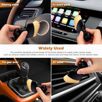 Plush microfiber towel wiping down a glossy automotive center console surface without streaks.