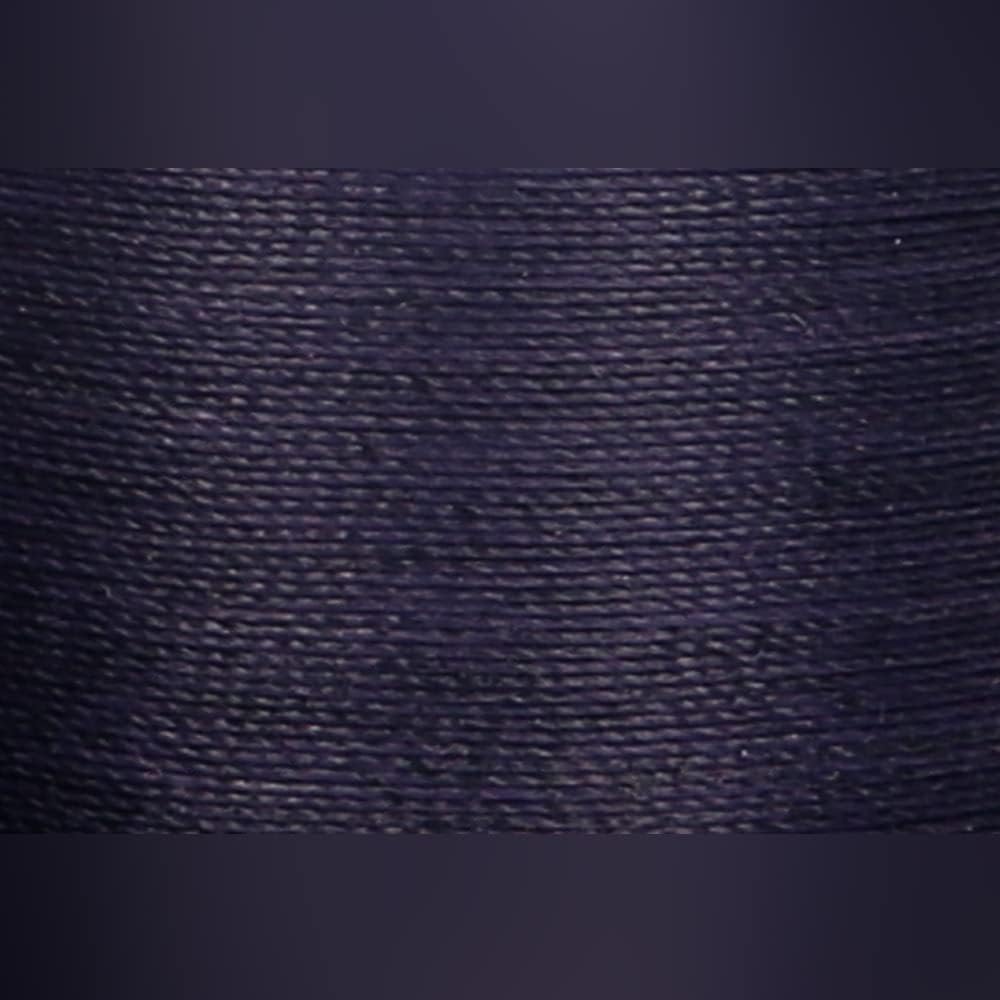 Close up of Navy hand quilting thread spool label and color