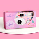 Xo Fetti ERAS Disposable Camera front view showing the sleek white body with colorful pop star icons and built in flash.